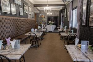 a restaurant with tables and chairs and a dining room at Marilyn Boutique Hotel in Durban