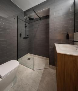 a bathroom with a shower and a toilet and a sink at Casa Tomás Boutique Hotel in Seville