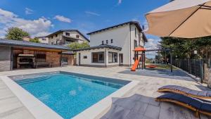 a swimming pool in the backyard of a house at Villa Tia by Villas Guide in Karlovac