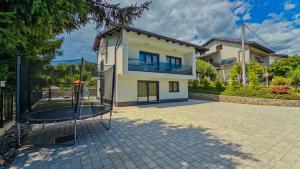 a house with a basketball hoop in front of it at Villa Tia by Villas Guide in Karlovac