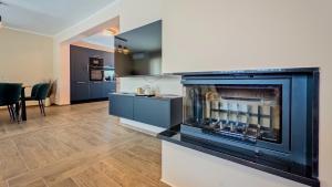 a living room with a fireplace and a table at Villa Tia by Villas Guide in Karlovac