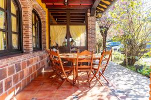 a wooden table and chairs on a patio at Hotel El Bricial in Soto de Cangas +34 photos