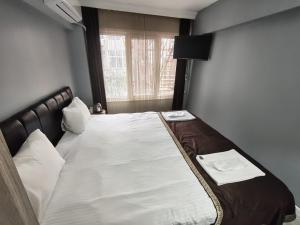 a large bed in a room with a window at Sun Suites in Istanbul