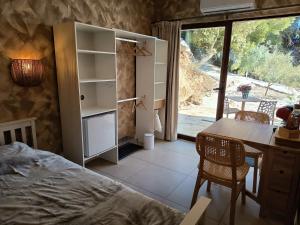 a bedroom with a bed and a desk and a table at La Única in Coín