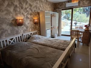 a bedroom with two beds and a desk and a window at La Única in Coín