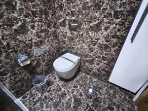 a bathroom with a toilet and a trash can at Sun Suites in Istanbul +25 photos