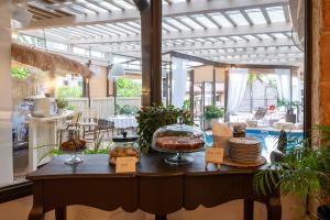 a room with a table with food on it at Cnaan Village Boutique Hotel & Spa in Had Nes