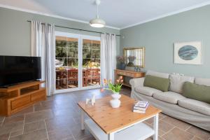 a living room with a couch and a table at Villa Morris in Nydri