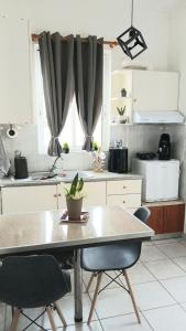 a kitchen with a table and two chairs in it at Welcome studio in Preveza