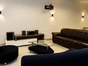 a living room with a couch and a coffee table at Royal Lodge in Sibasa