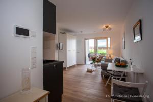 a kitchen and a living room with a table at Seensucht in Bodman-Ludwigshafen