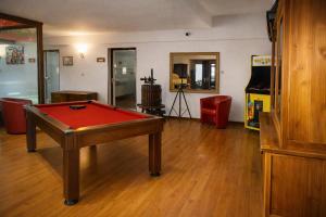 a living room with a pool table in the middle at Enzo Hôtels - ST Eloy Metz Amneville in Amnéville