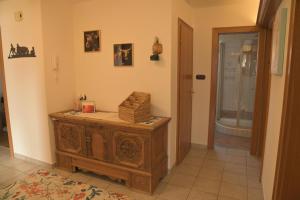 a room with a wooden cabinet with a box on it at Appartement Naunspitzblick in Ebbs +16 photos
