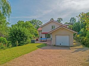 a house with a garage and a brick driveway at Villa Galante in Meylan