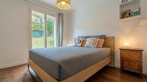 a bedroom with a large bed and a window at Villa Galante in Meylan +27 photos