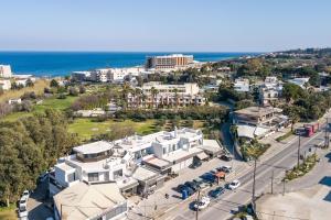 an aerial view of a city with buildings and the ocean at Kallithea living in Koskinou