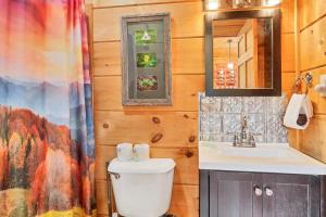 a bathroom with a toilet and a sink at Holy Smokes in Townsend +25 photos