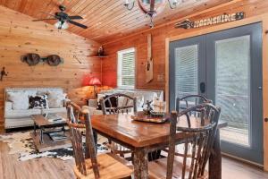 a dining room with a wooden table and chairs at Holy Smokes in Townsend