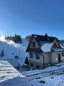a house with snow on the roof at Chata Barvinok in Litmanová