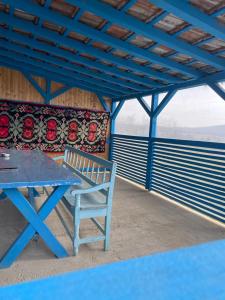 a blue picnic table and a blue bench on a patio at Casa Enisala in Enisala