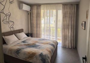 a bedroom with a large bed and a window at Fresh SPA Relax Velingrad in Velingrad