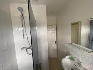 a bathroom with a sink and a toilet and a mirror at Woodstock in York