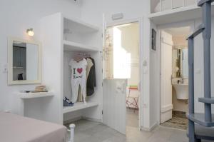 a bedroom with a door leading to a bathroom at Depis suites naxos in Naxos Chora +29 photos