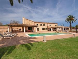 a house with a swimming pool in front of it at S'hort d'en Bonet in Santanyi