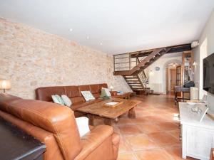 a living room with a couch and a table at S'hort d'en Bonet in Santanyi
