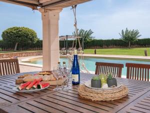 a table with a plate of food and a bottle of wine at S'hort d'en Bonet in Santanyi
