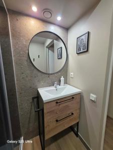 a bathroom with a sink and a mirror at D20 apartamentai in Mažeikiai +21 photos
