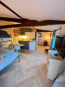 a room with a bunk bed and a kitchen at Grand Studio Cocon & Spa in Mosnay