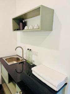 a kitchen with a sink and a counter top with a sink at The Dutch Station Hotel in Ambalangoda +52 photos