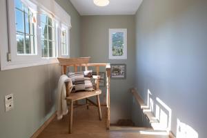 a chair in a hallway with a window and stairs at Villa Morris in Nydri +59 photos