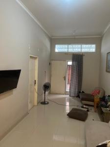 a living room with a couch and a window at Leon Mansion in Pulau Layang