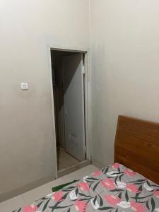 a bedroom with a door leading into a room at Leon Mansion in Pulau Layang