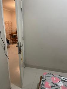 an open door to a room with a table at Leon Mansion in Pulau Layang