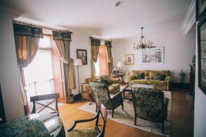 a living room with a couch and a table and chairs at Pazo Santa Teresa in Redondela +17 photos
