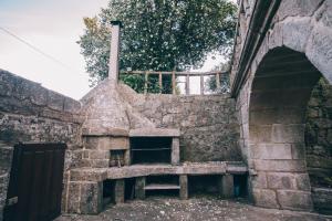 a brick oven with a bench in a stone wall at Pazo Santa Teresa in Redondela