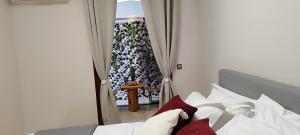 a bedroom with a bed and a view of a balcony at abpikermistudios3 in Pikérmion