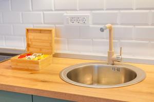a kitchen sink with a faucet on a counter at Relaxing 2 bedroom apartment with Bay View and Parking in Prčanj +26 photos