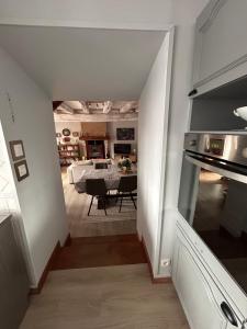 a view of a kitchen and a dining room with a table at Gîte de l horloge in Déols