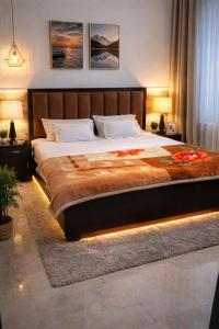 a bedroom with a large bed with lights on it at Hotel HP Palace in Gorakhpur