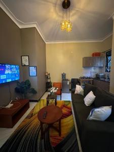 a living room with a couch and a table at Sky world homes in Kampala