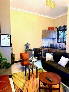 a living room with a couch and a table at Sky world homes in Kampala