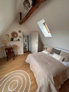 a bedroom with a large bed and a table at Gîte de l horloge in Déols