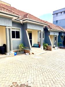 a house with a brick driveway in front of it at Sky world homes in Kampala