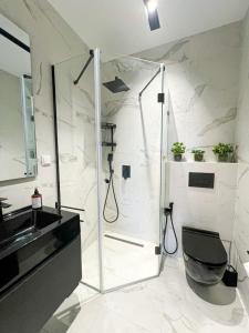 a bathroom with a shower and a sink at Only You in Sidi Daoud