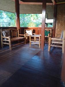 a room with chairs and a table and windows at Greenviews Resort & Restaurant Port Barton in San Vicente +35 photos