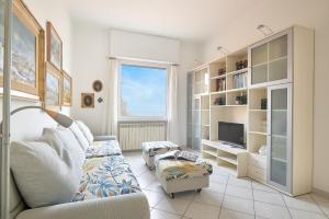a living room with a couch and a tv at SottoVento in Imperia